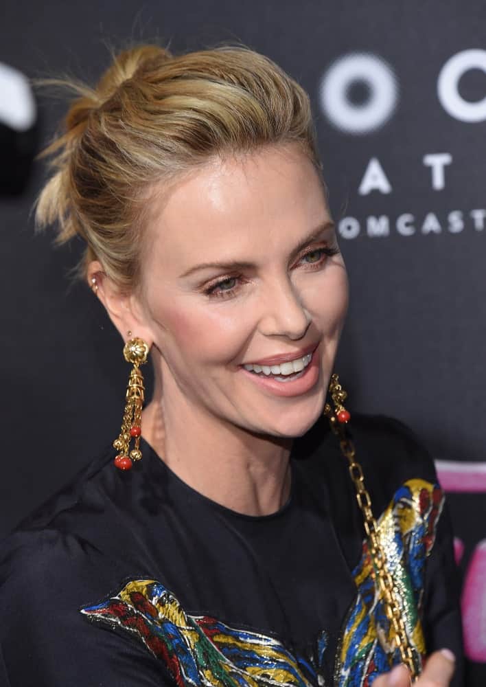 Charlize Theron was seen at the "Tully" Los Angeles Premiere on April 18, 2018, in a black printed dress and her blonde hair arranged into a voluminous updo hairstyle.