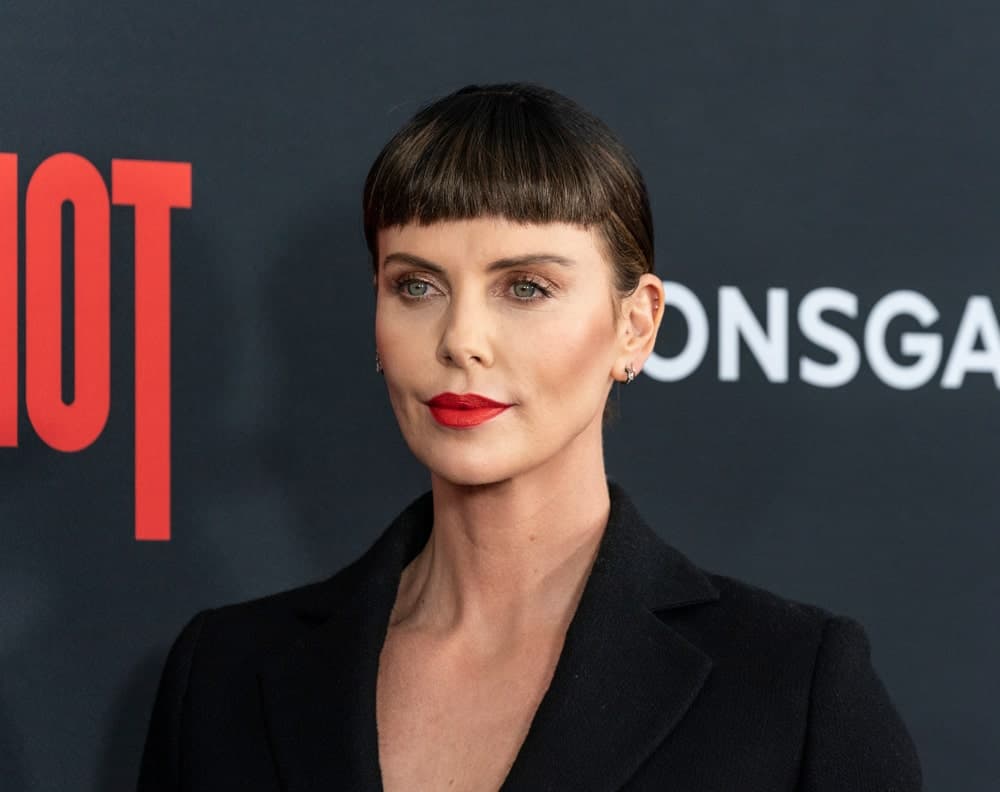 During the premiere of Long Shot at AMC Lincoln Center Theater on April 30, 2019, the actress flaunted a neat updo with short blunt bangs. She finished the look with a black suit and red lipstick.