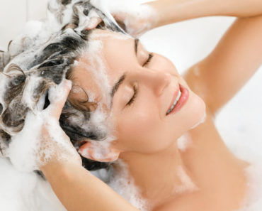 Woman shampooing her hair.