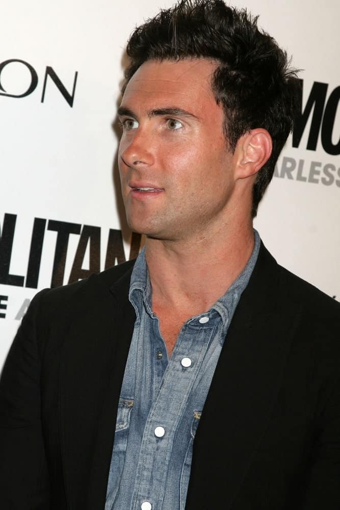 A tan Adam Levine was at Cosmopolitan's 2009 Fun Fearless Awards held at the SLS Hotel in Beverly Hills, CA on March 2, 2009. He wore a smart casual ensemble outfit with his short tousled and spiked hairstyle.