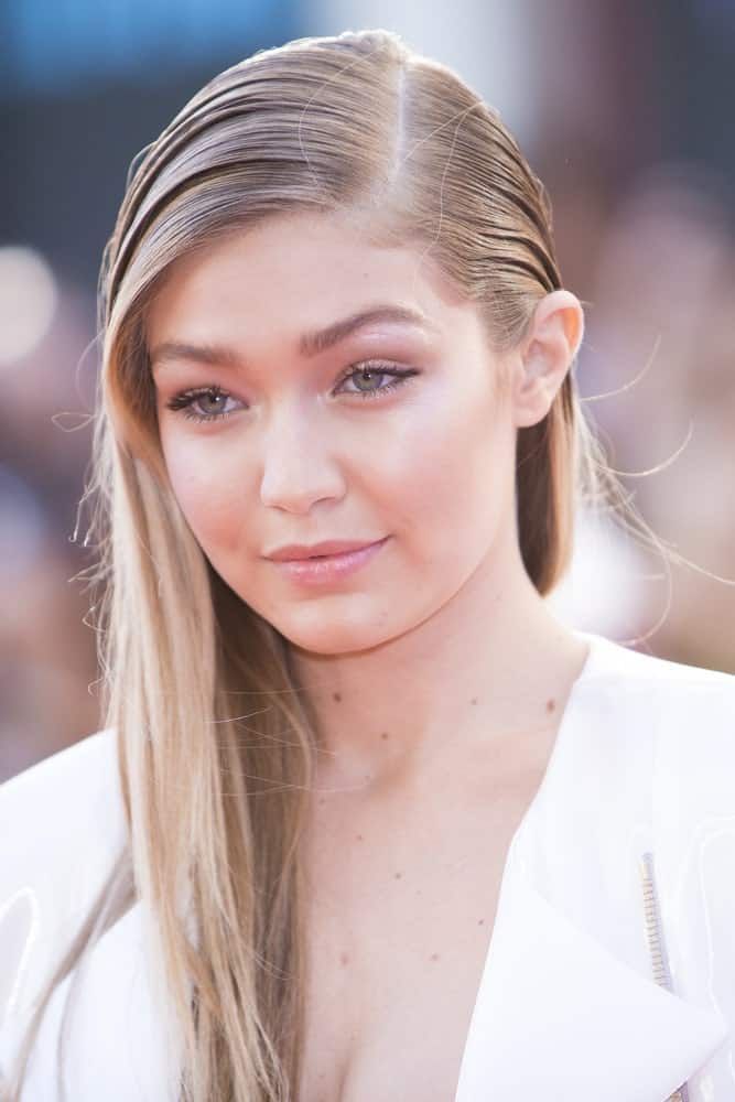 A young Gigi Hadid wore a white outfit with her side-swept slick hairstyle with highlights when she arrived at the MuchMusic Video Awards on June 21, 2015 in Toronto.