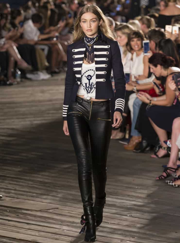 Gigi Hadid walked the runway at Tommy Hilfiger Women's Fashion Show during New York Fashion Week at Pier 19 On September 9, 2016 in New York. She looked sexy in her black leather pants and long wavy tousled hairstyle.