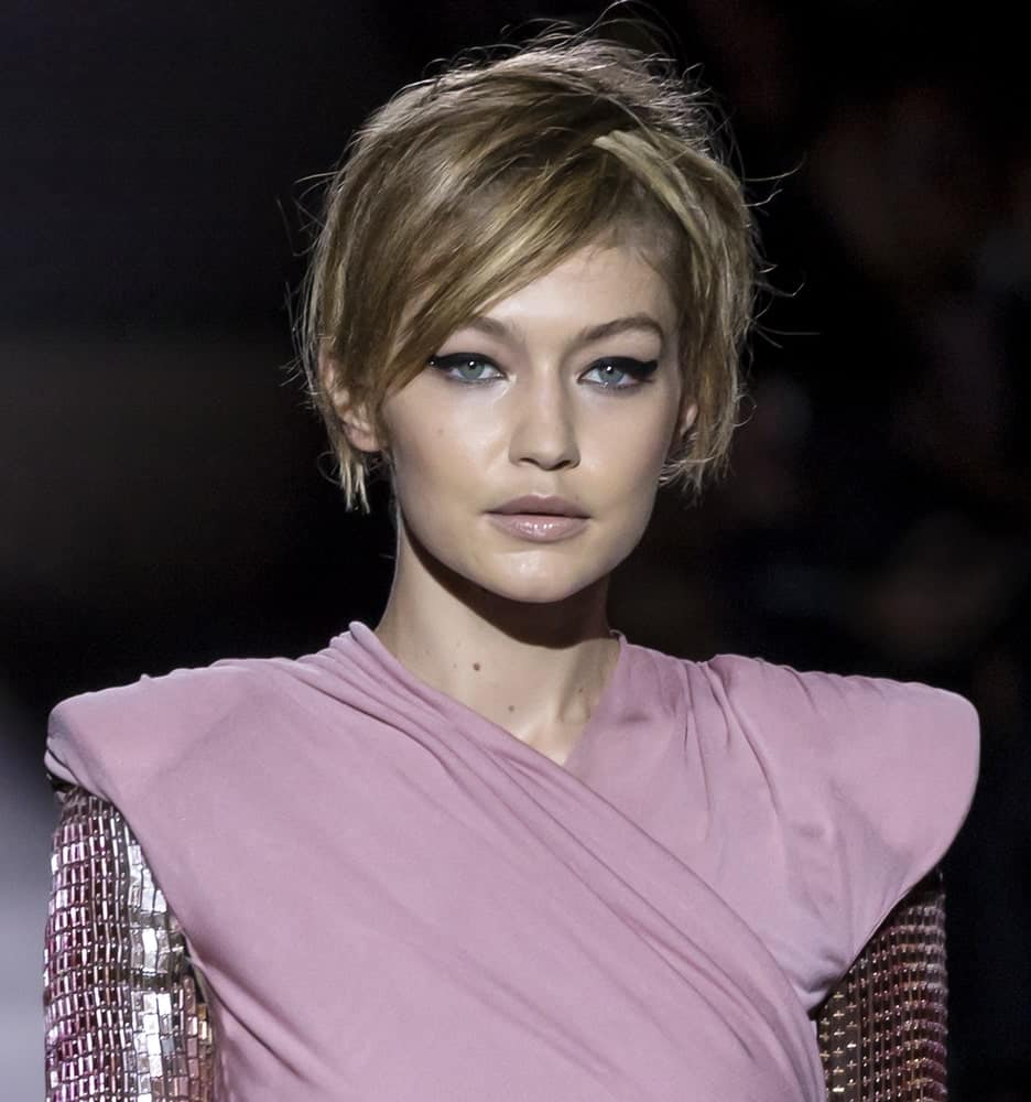 On September 06, 2017, Gigi Hadid had a short hairstyle with messy side-swept bangs when she walked the runway at the Tom Ford Spring Summer 2018 fashion show during the New York Fashion Week.