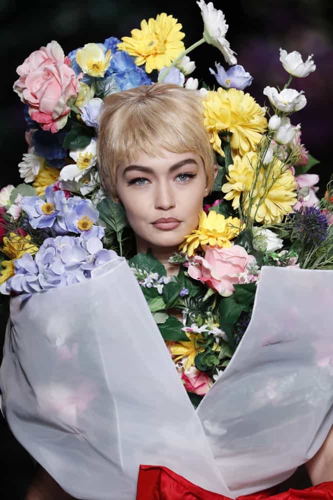 Gigi Hadid was dressed as a bouquet of flowers with her blond pixie hairstyle at the runway of the Moschino Spring/Summer 2018 fashion show on September 21, 2017 in Milan, Italy.