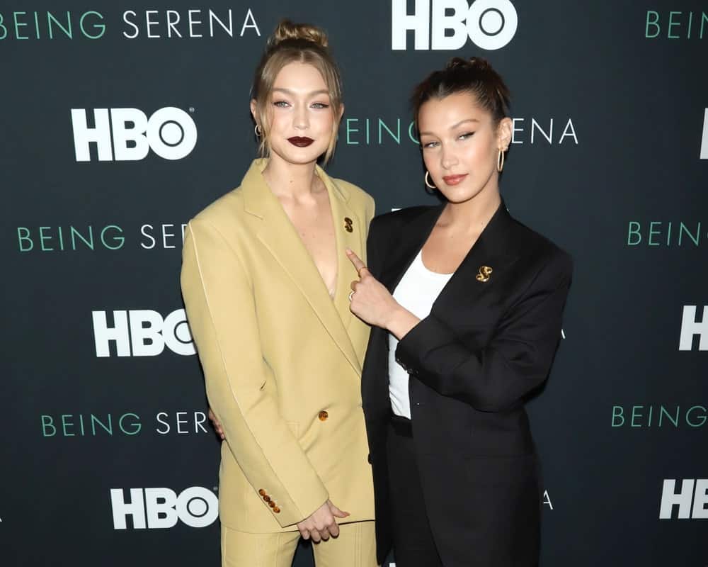 Gigi Hadid and Bella Hadid attended the premiere of "Being Serena" at the Time Warner Center on April 25, 2018, in New York City. Gigi was stunning in tan outfit, high bun hairstyle with curtain bangs and bold lips.