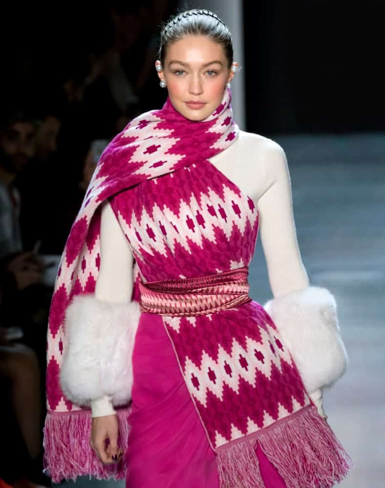 On February 11, 2018, Gigi Hadid walked the runway at the Prabal Gurung Fall Winter 2018 fashion show during New York Fashion Week. She was dressed in pink and white to go with her upstyle hair with a hairband.