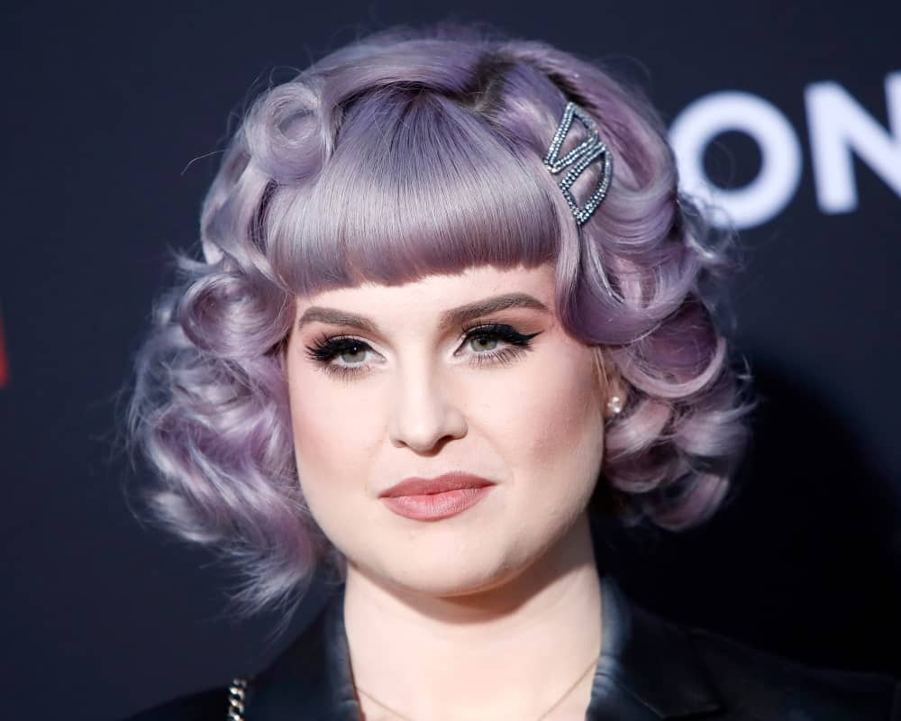 A headshot of Kelly Osbourne on August 21, 2019, showcasing her stunning purple hairstyle. She looks absolutely cute with this hairstyle and hair color. 