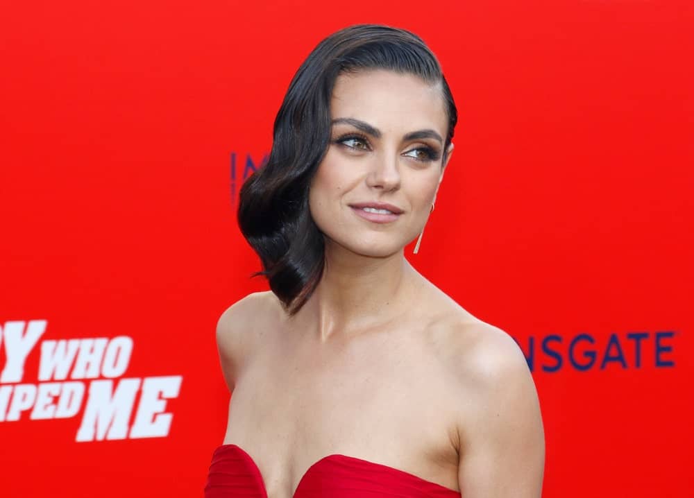 Mila Kunis was stunning and elegant in her sexy red dress complemented by a vintage look to her slick side-swept wavy hairstyle at the Los Angeles premiere of ‘The Spy Who Dumped Me’ held at the Regency Village Theater in Westwood last July 25, 2018.