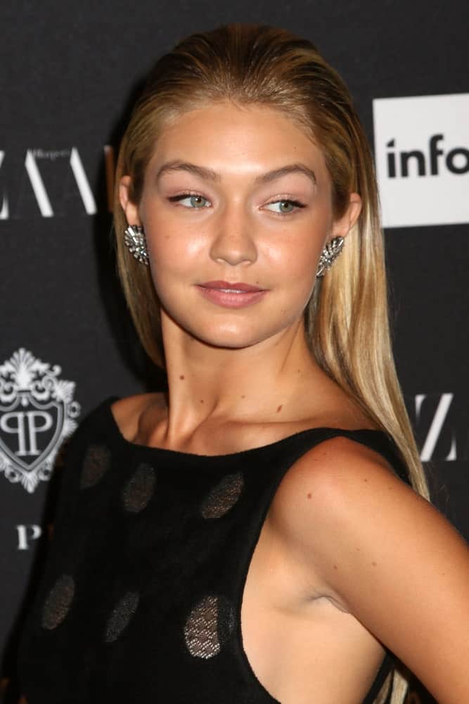 Gigi Hadid’s lovely black dress was a perfect pair for her slicked back long and straight hair with highlights at the Harper’s Bazaar ICONS event at the Plaza Hotel on September 5, 2014, in New York City.
