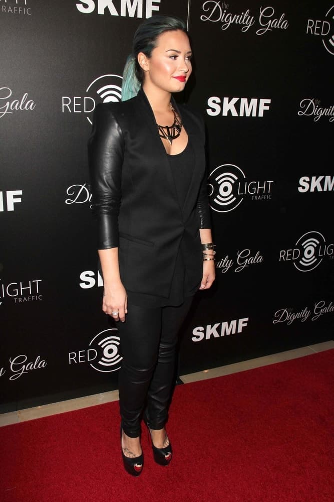 Demi Lovato’s red lips paired quite well with her black leather outfit and tight ponytail with blue highlights at the Dignity Gala and Launch of Redlight Traffic App at Beverly Hilton Hotel on October 18, 2013, in Beverly Hills, CA.