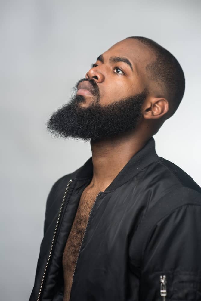 A man with a thick and contoured beard.