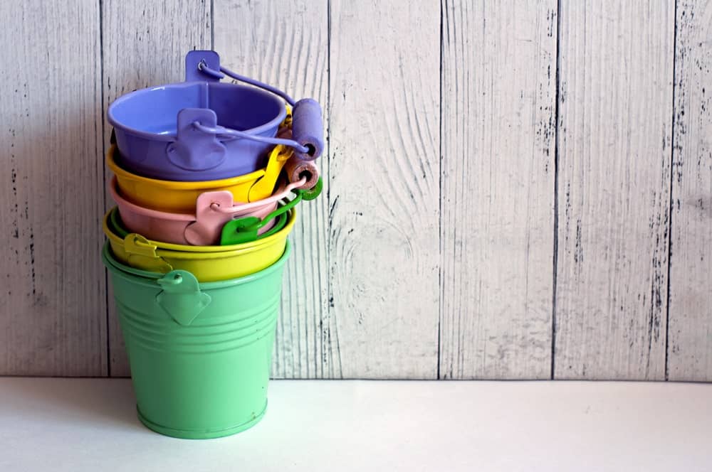 A stack of miniature colorful tin pails.